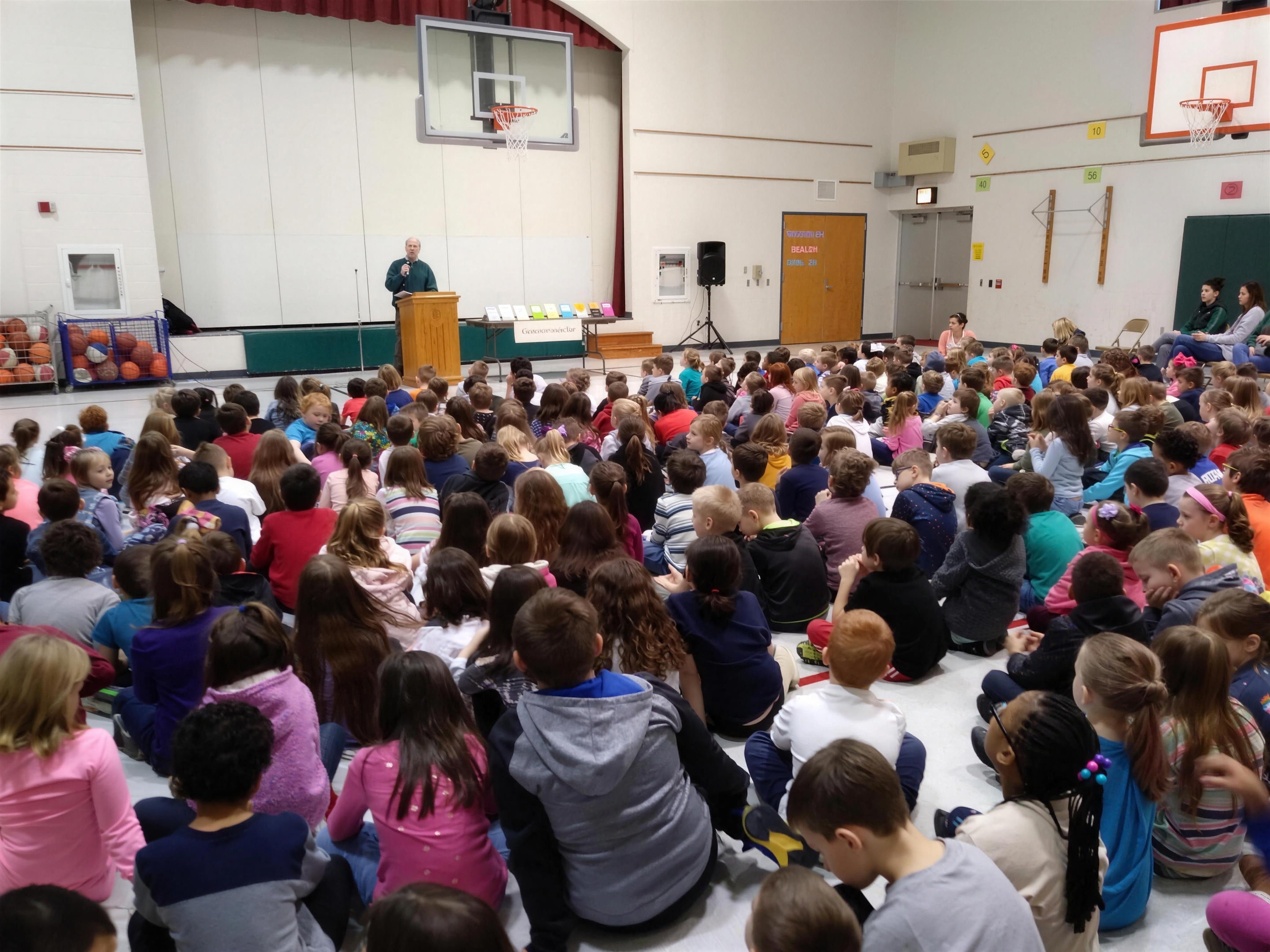 Tom presenting at a school assembly